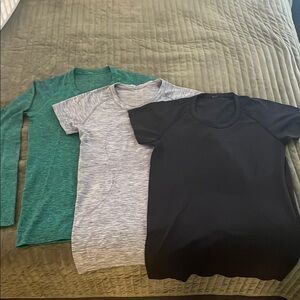 Bundle of Three Lulu lemon tops in Green, Gray, and Black sz 10